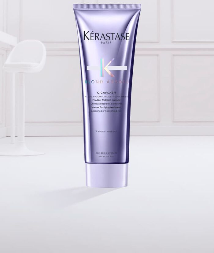 Tube de masque capillaire Kerastase Blonde Absolu Cicaplasth sur fond clair, avec une texture cremeuse en sortie du tube.