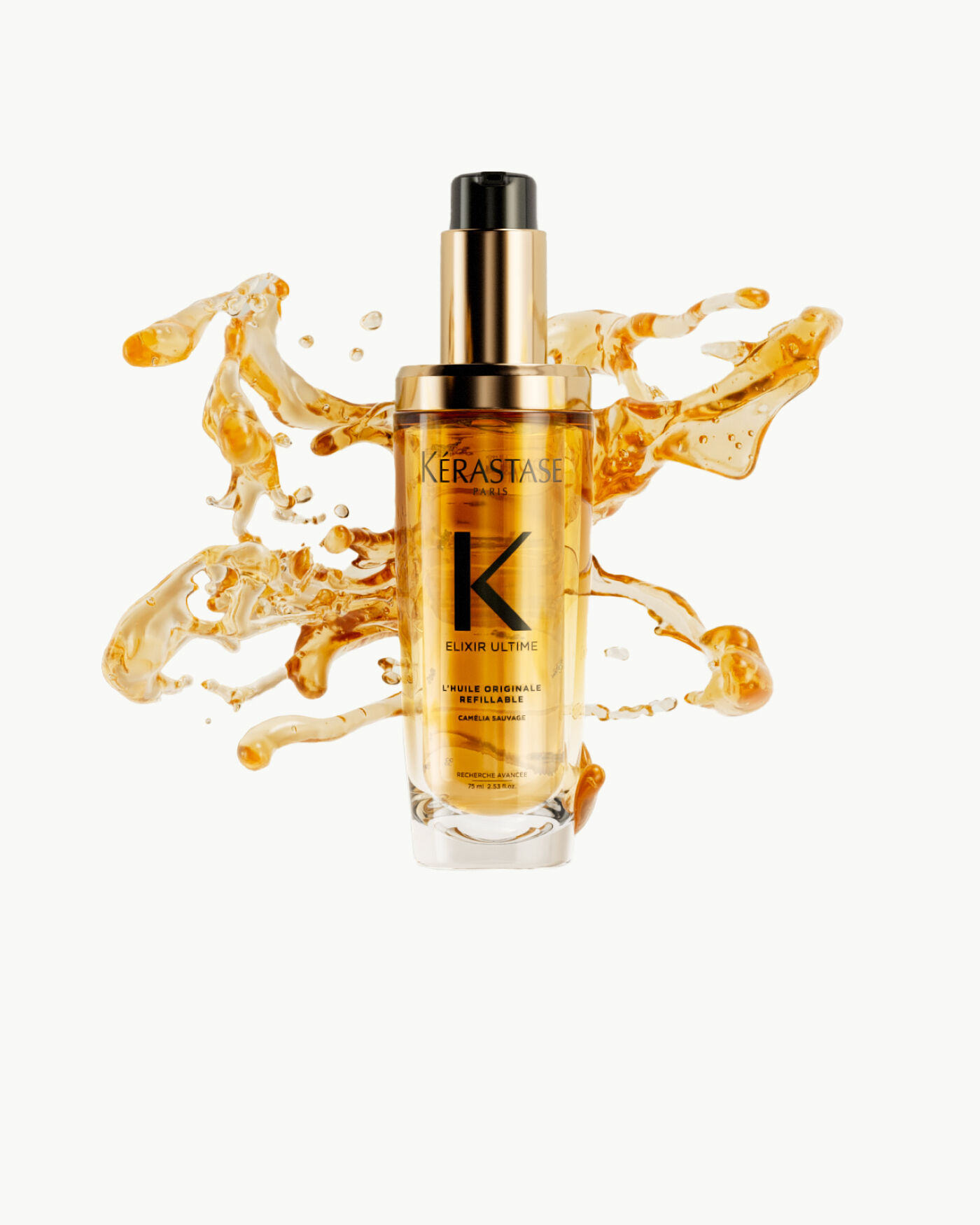 Flacon de serum Kerastase Elixir Ultime, entoure de gouttes d'huile doree sur fond clair.