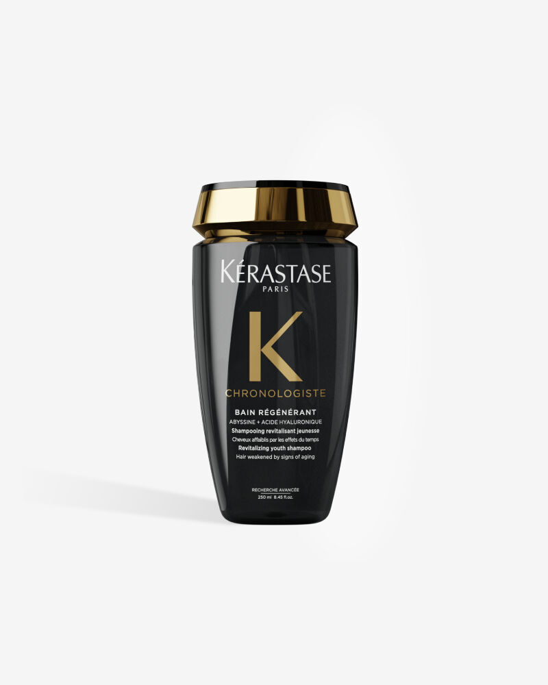 Le shampooing revitalisant jeunesse Kerastase Chronologiste Bain Regenerant dans son flacon noir elegant au bouchon dore.