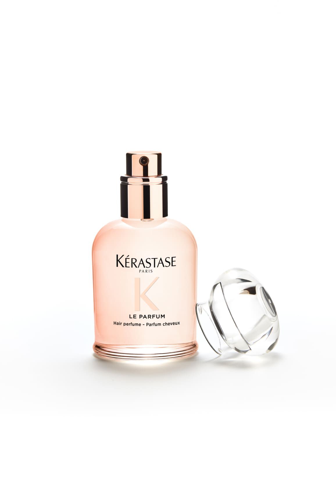 Flacon du parfum Gloss Absolu, son bouchon est pose a cote de lui