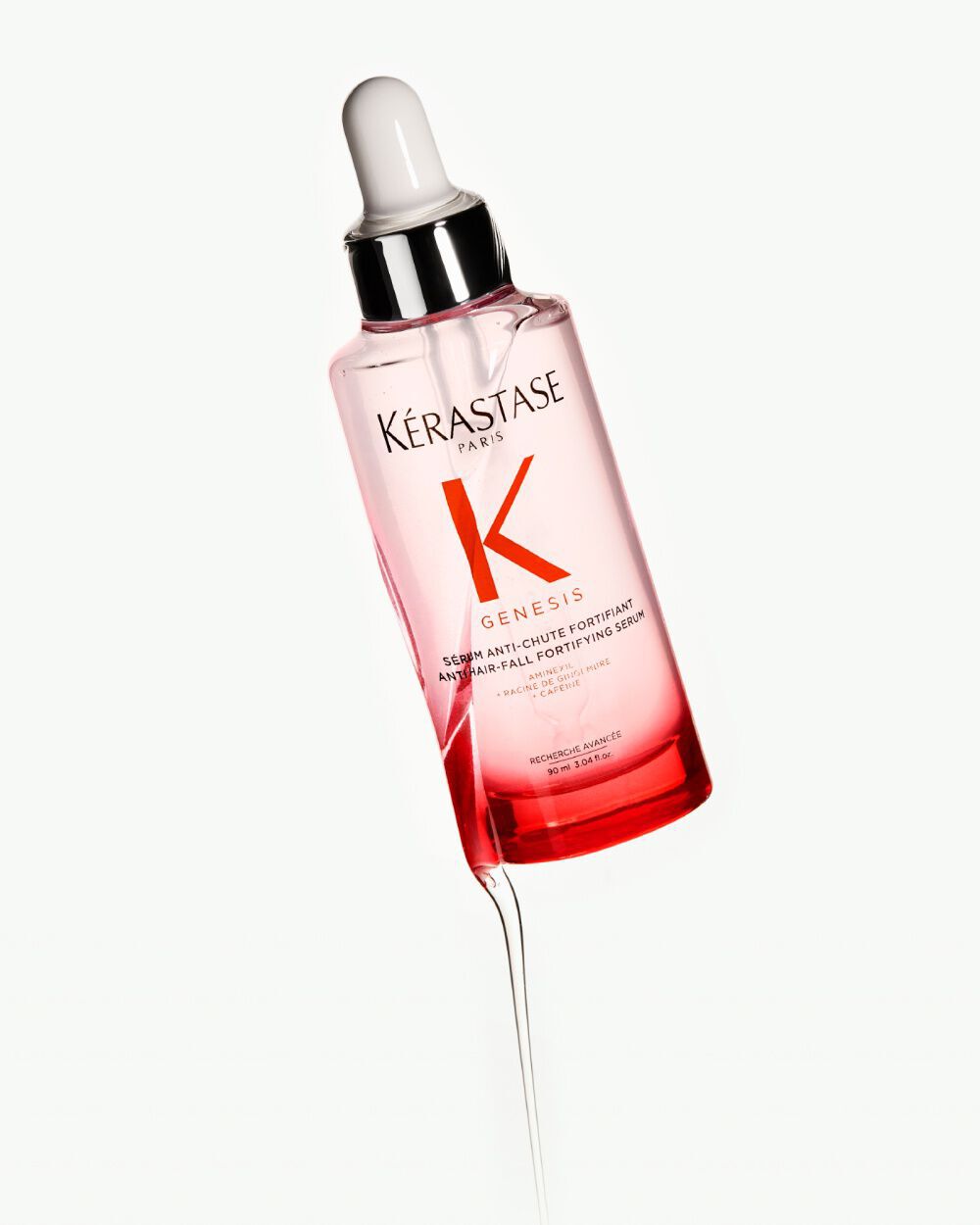 Flacon de serum Kerastase Genesis avec pipette, sur fond clair.
