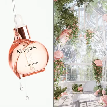 Le flacon des glaze drops Gloss Absolu suspendu dans l'air avec un jardin de roses.