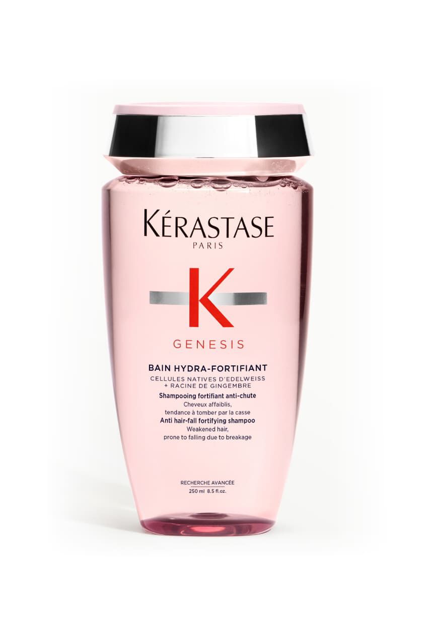 Flacon transparent rose de shampooing Kerastase Genesis Bain Hydra-Fortifiant pour cheveux affaiblis, incline.