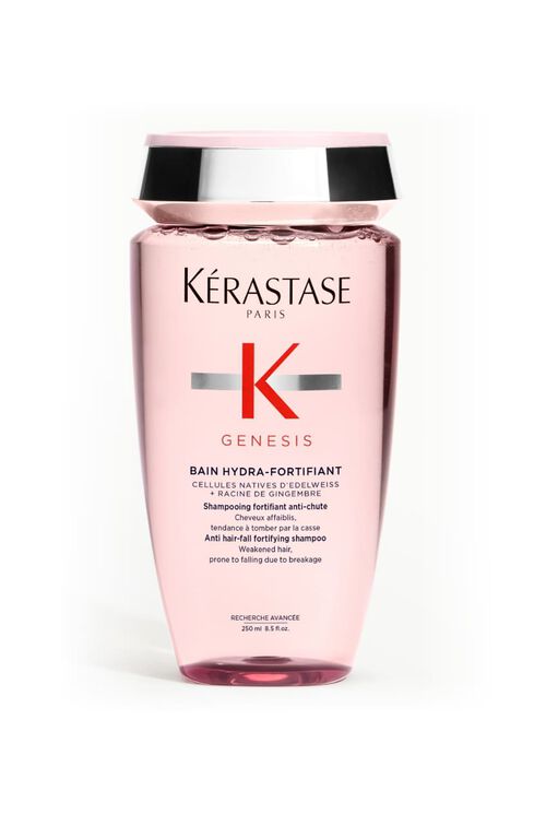 Flacon transparent rose de shampooing Kerastase Genesis Bain Hydra-Fortifiant pour cheveux affaiblis, incline.