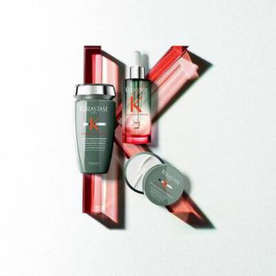 Product display featuring various skincare bottles and jars arranged with a minimalistic design on a light background.