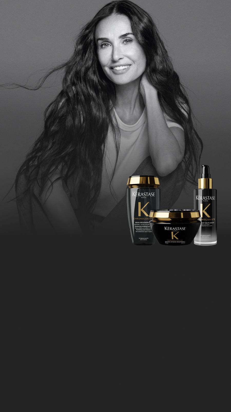 Un portrait en noir et blanc de Demi Moore aux longs cheveux ondules, a cote de trois produits Kerastase Chronologiste en couleur.