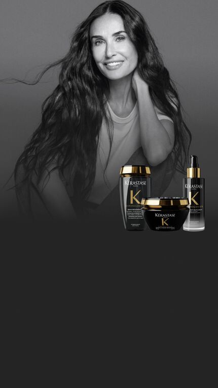 Un portrait en noir et blanc de Demi Moore aux longs cheveux ondules, a cote de trois produits Kerastase Chronologiste en couleur.