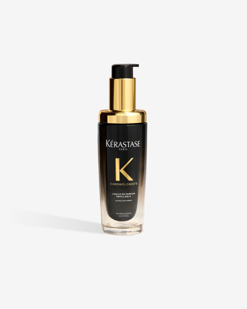 L'Huile de Parfum Kerastase Chronologiste rechargeable dans son flacon luxueux au degrade noir et transparent avec une pompe doree.