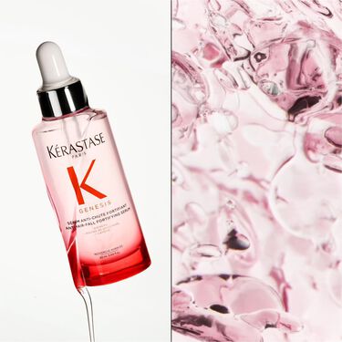 le serum fortifiant genesis anti-chute suspendu dans l'air avec des fleurs roses pales