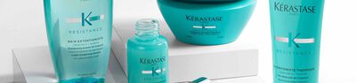 Gamme de produits capillaires Kerastase Resistance, notamment un shampoing, un serum et un masque, presentes sur un fond clair.