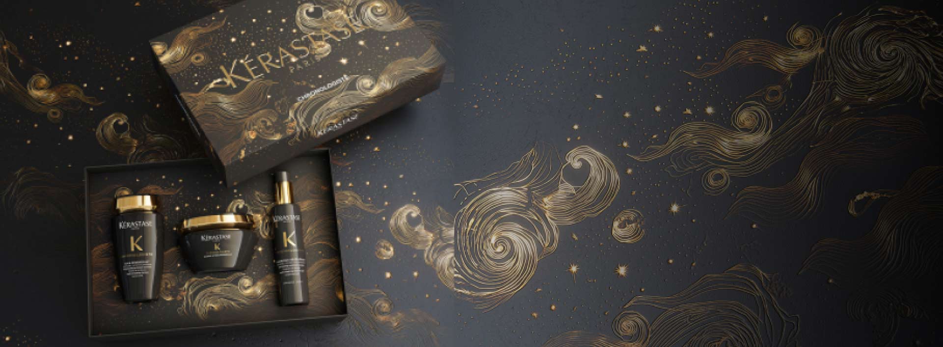 Coffret de produits capillaires Kérastase sur fond artistique doré et noir, mettant en valeur le luxe et l'élégance.