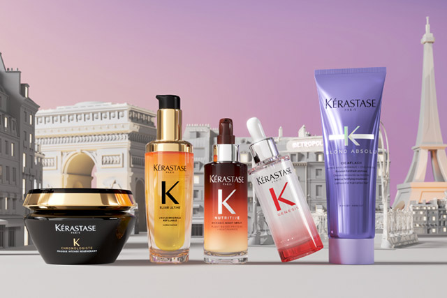 Gamme de produits capillaires Kérastase avec une vue stylisée de Paris en arrière-plan, mettant en avant des flacons et un bol.